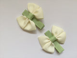 Two hair clips with beige & green grosgrain bows