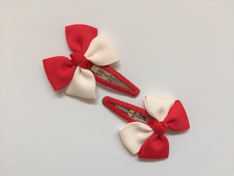 Two hair clips with red & peach grosgrain bows