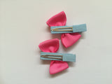 Two hair clips with pink grosgrain bows